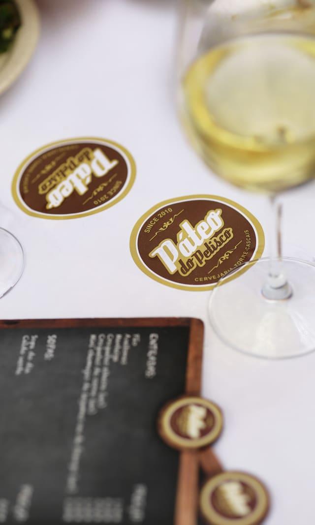 Páteo do Petisco coasters on the table