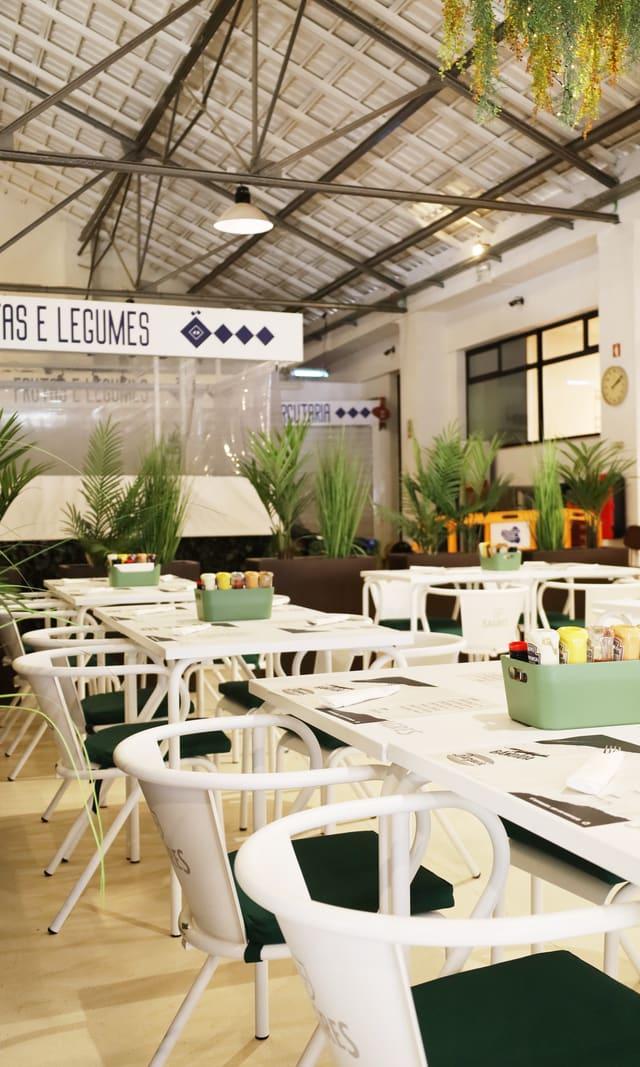 Restaurant dining room with plants and set tables
